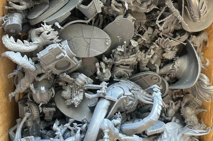 A box of 3D printed resin miniatures ready to paint