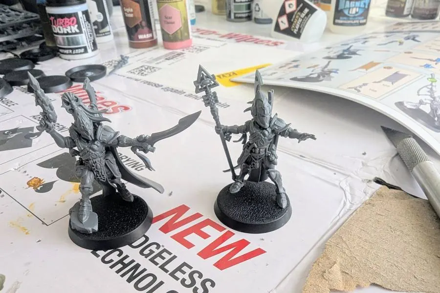 Two freshly assembled Aeldari models on the build bench