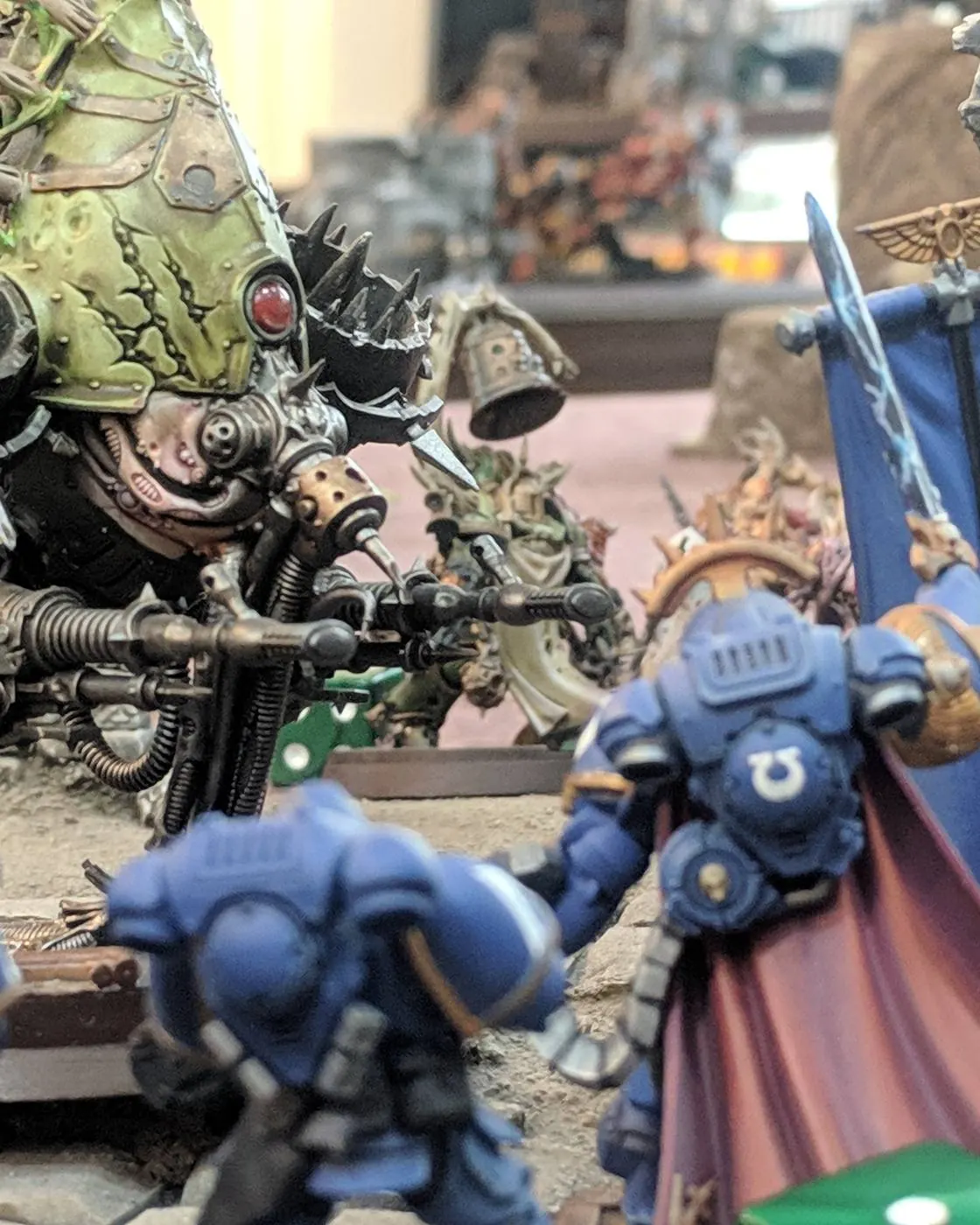 Ultramarines advancing on a Plague Hulk during a game